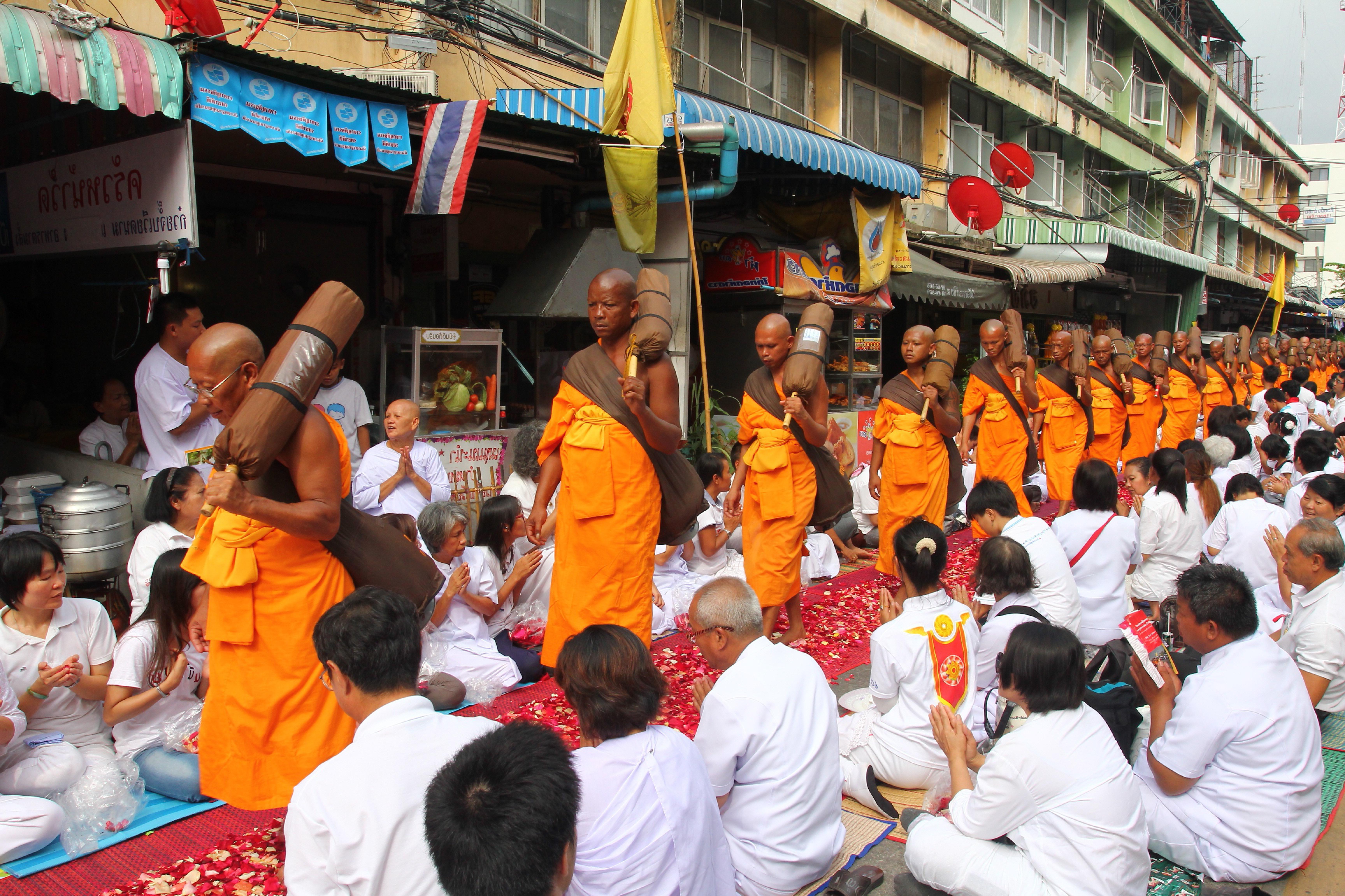 Thailand monks walking petal ceremony.